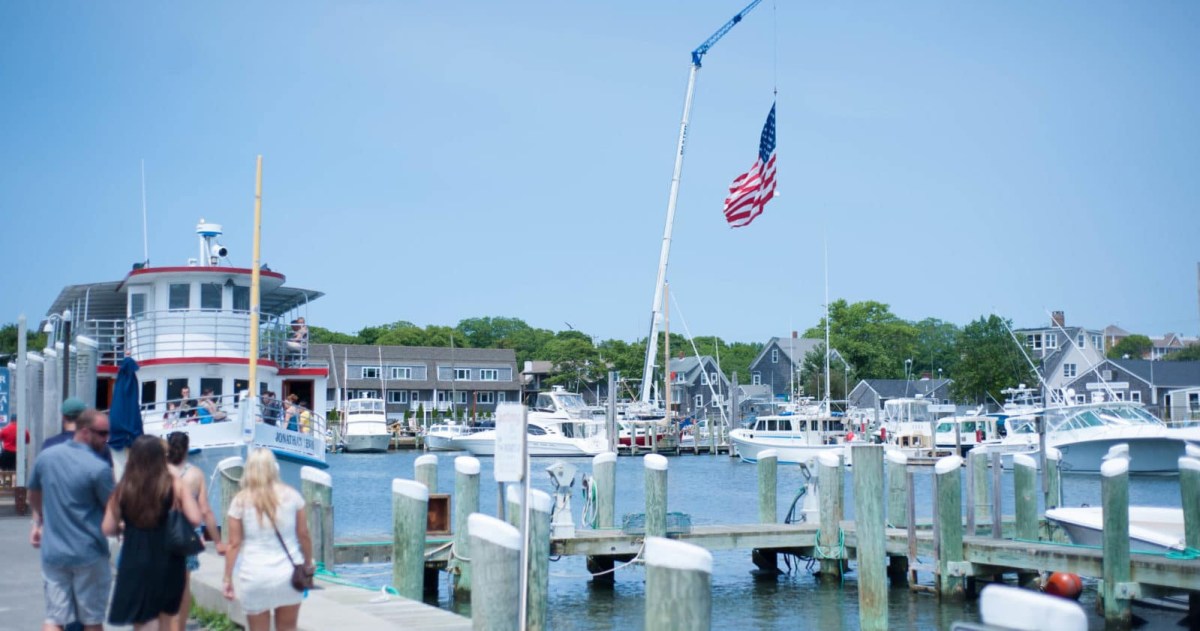 Private Tours Image 1 a group of people on a dock next to a body of water