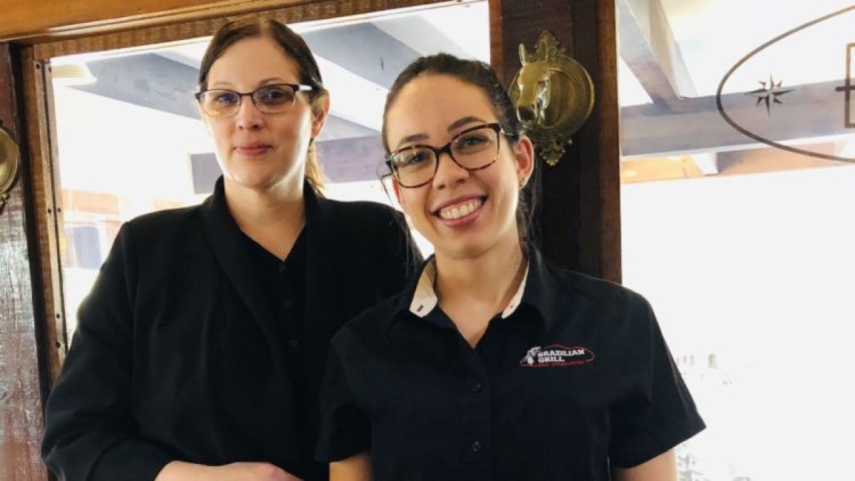 a person standing in front of a window posing for the camera