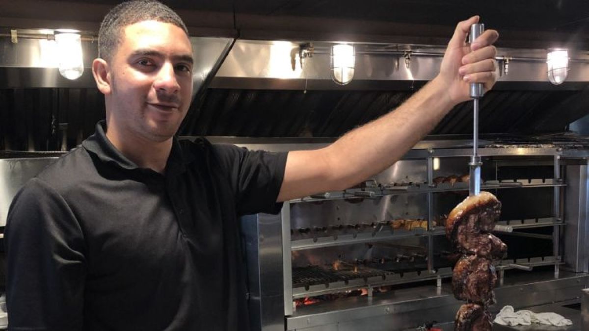 a man standing in front of an oven