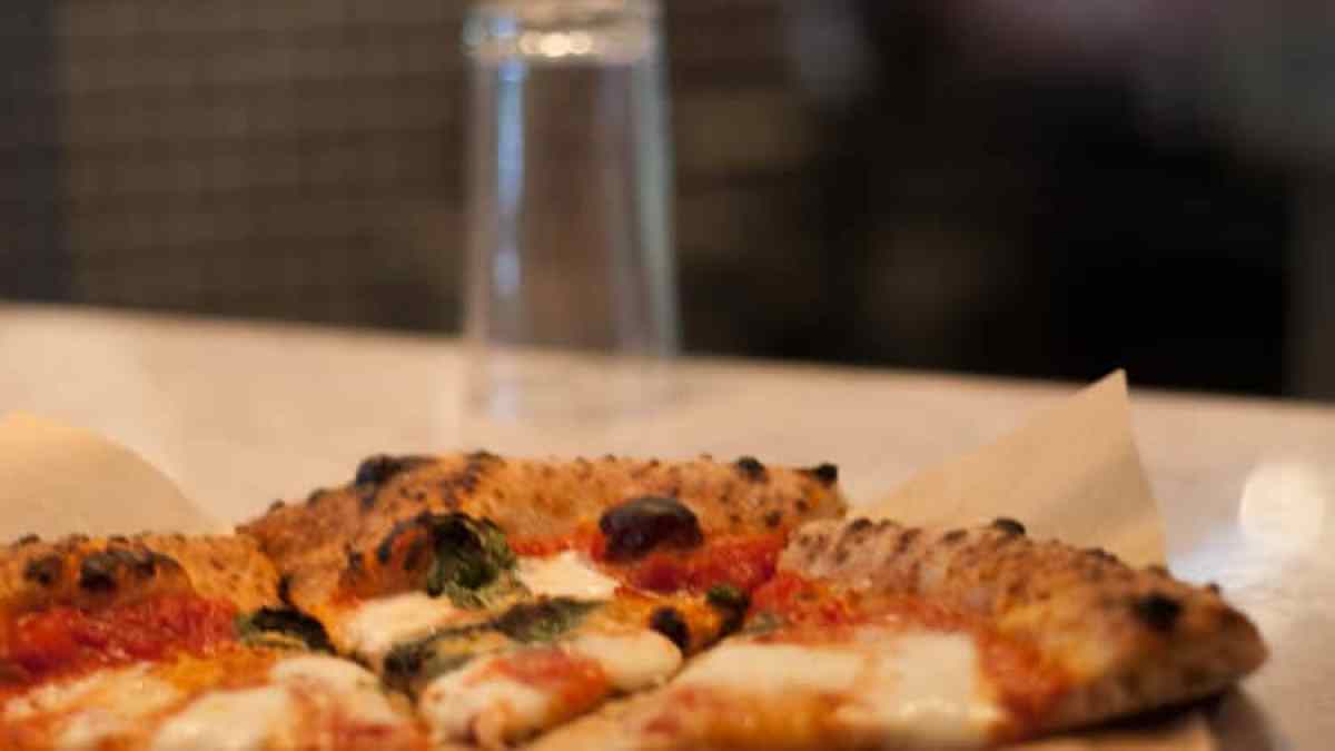 a close up of a slice of pizza sitting on top of a table