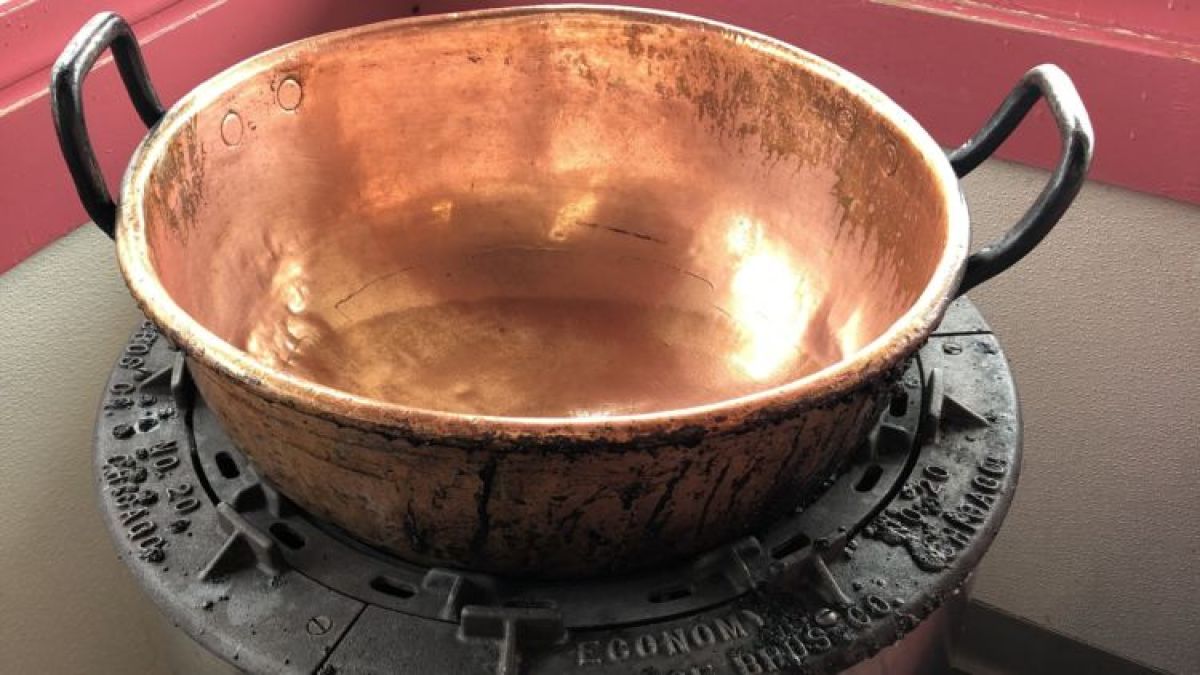 a bowl of soup sitting on top of a stove