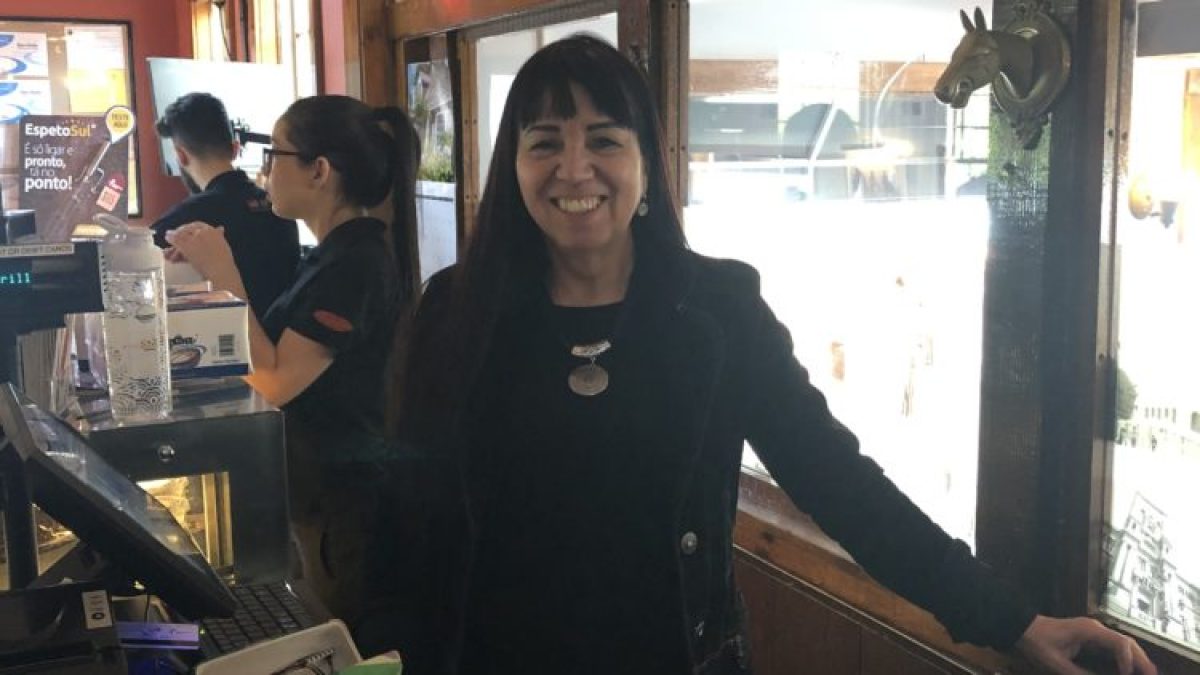 a man and a woman standing in front of a window