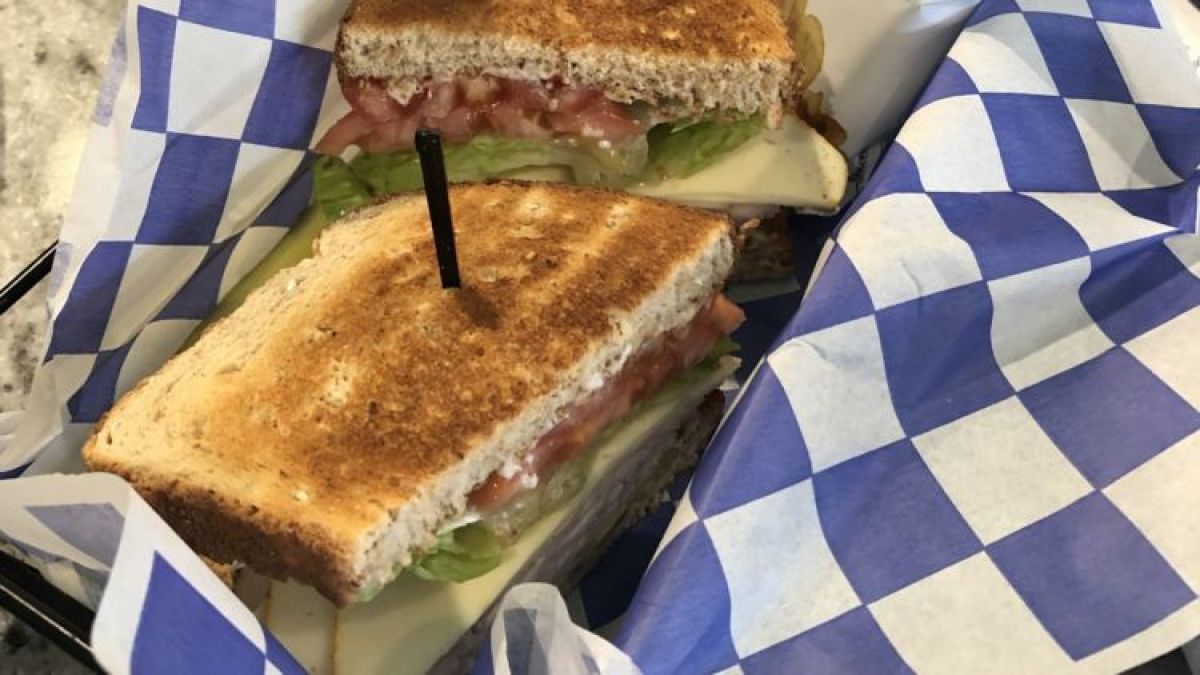 a cut in half sandwich sitting on top of a table