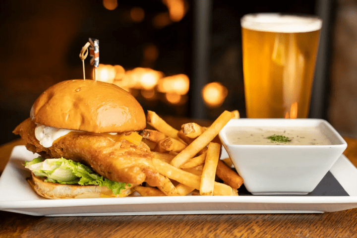 a plate of food with a sandwich and fries on a table